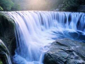 Columbia River Gorge waterfall wallpaper — long exposure photograph of wide waterfall with sunlight breaking through mist in Oregon